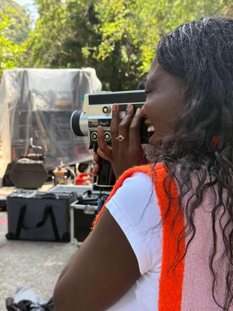 Mary Ann Anane behind a Super 8 camera on set.