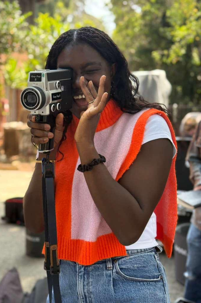 Mary Ann Anane behind a Super 8 camera on set.